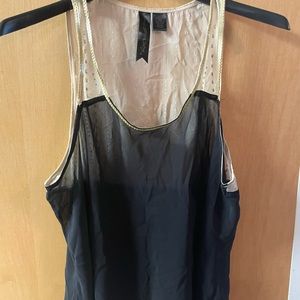 Sheer black top with cream color shoulders and design neckline